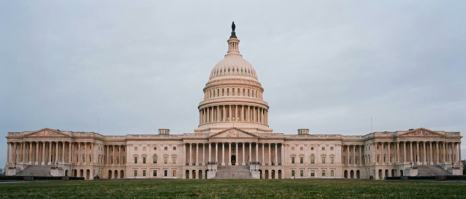 The United States Capitol at first light under an overcast sky